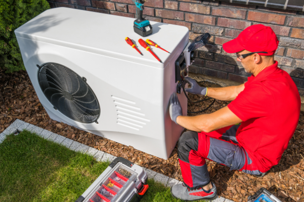 A worker installing a heat pump